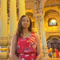 Dr. Amrita inside ornate golden building in India