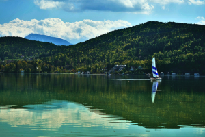 sailboat in lake ringed with mountains