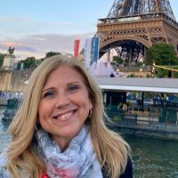 Dr. Colvin headshot in front of Eiffel Tower