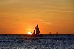 sailboat on ocean at sunset