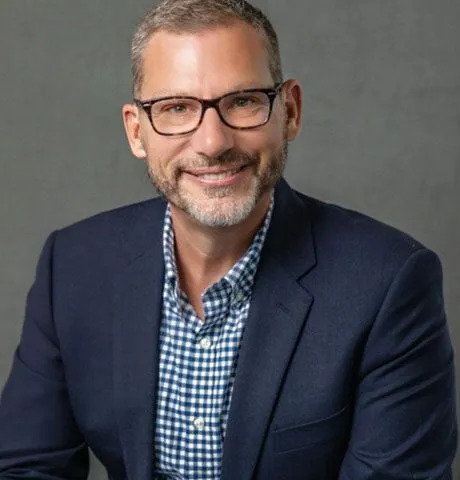 Chad Warzecha Guy sitting for headshot in front of grey screen