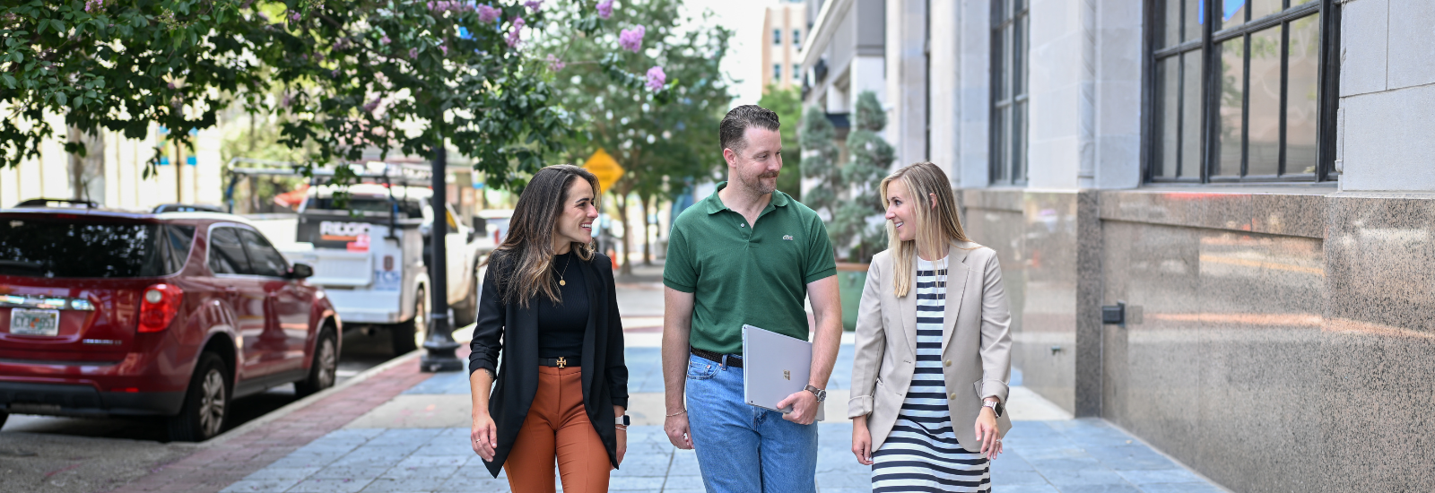 2 women and one man walking downtown