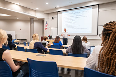 instructor teaching in a classroom of students