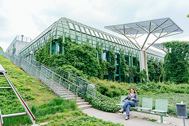 student sitting on a bench at university of warsaw library