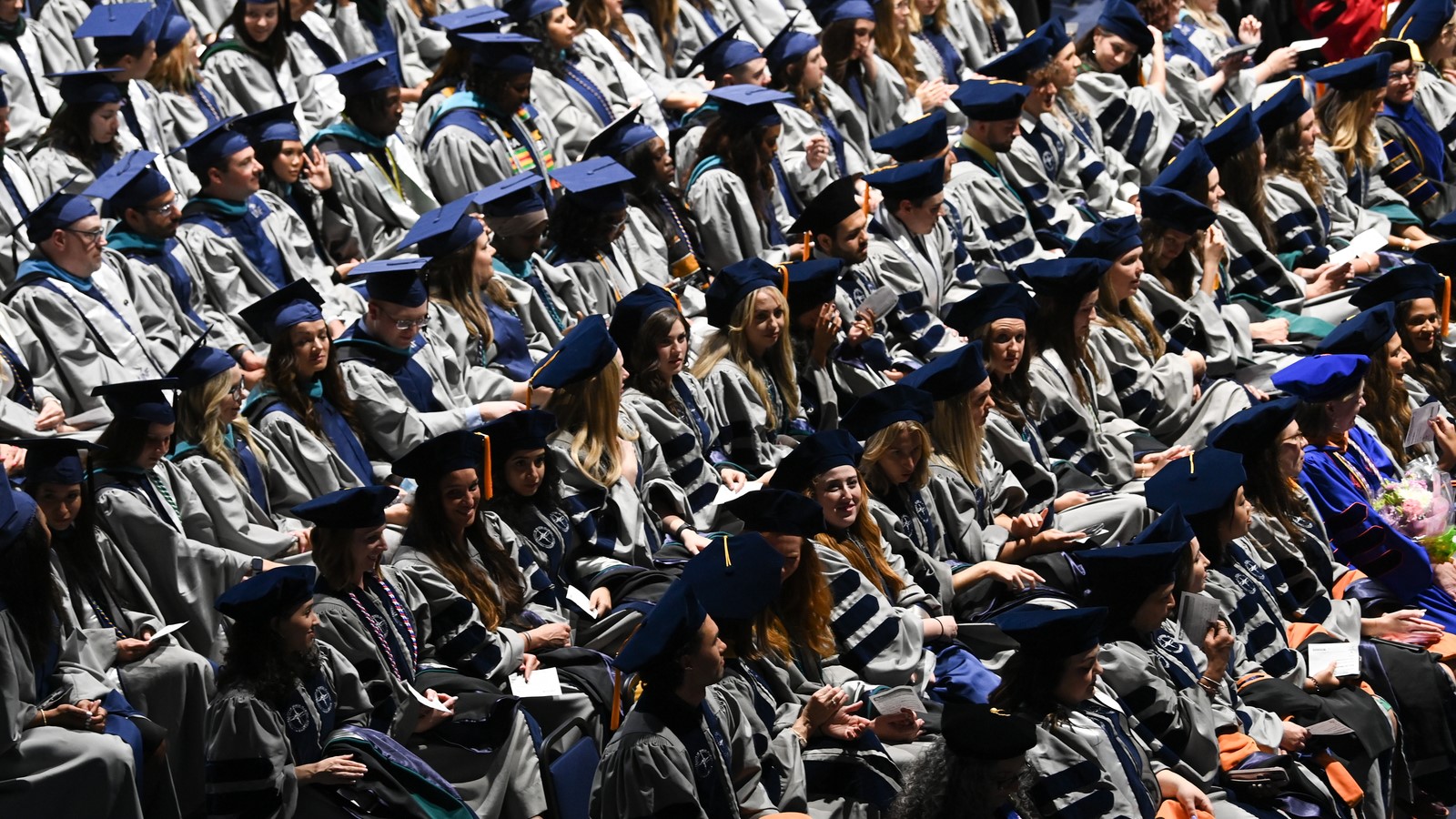 Graduate degree candidates sit during the ceremony.