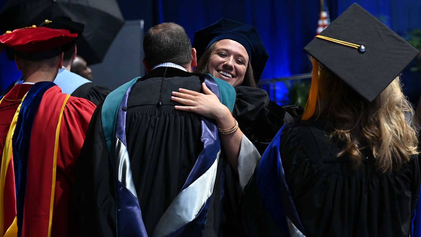 Professors congratulating graduates. 