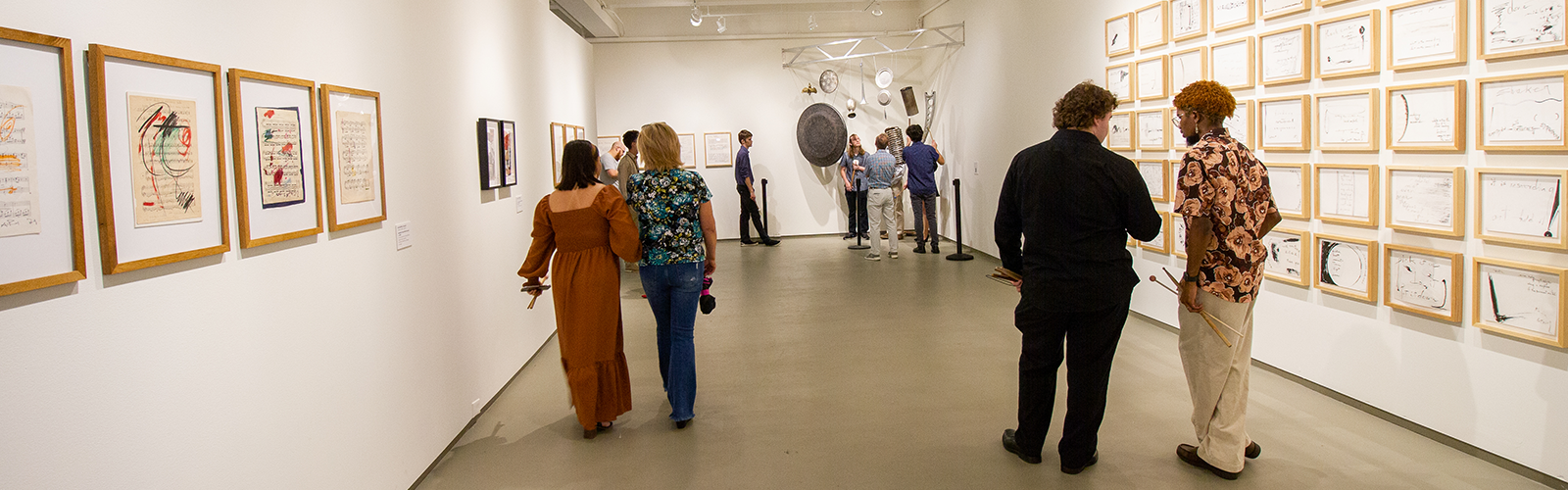 art lovers walking and talking in the middle of an exhibit