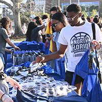 students picking up swag during a homecoming event