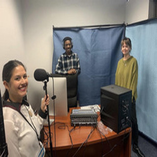 Group of three individuals in DHI Media Lab, podcast equipment on desk