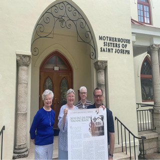 Four Individuals in front of Motherhouse Sisters of Saint Joseph Building