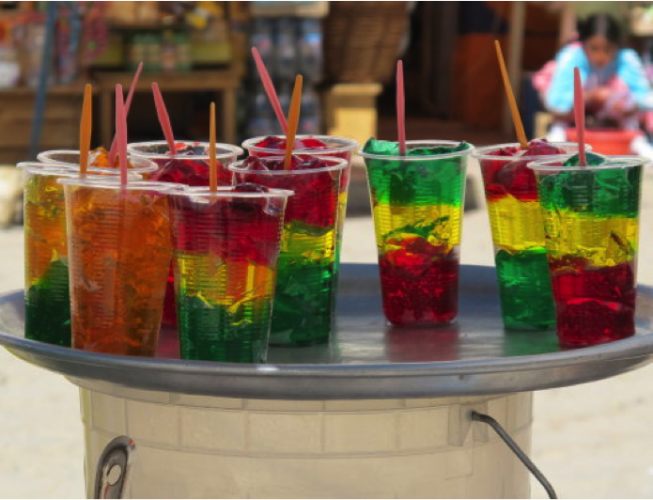 table with 10 red, yellow and green drinks