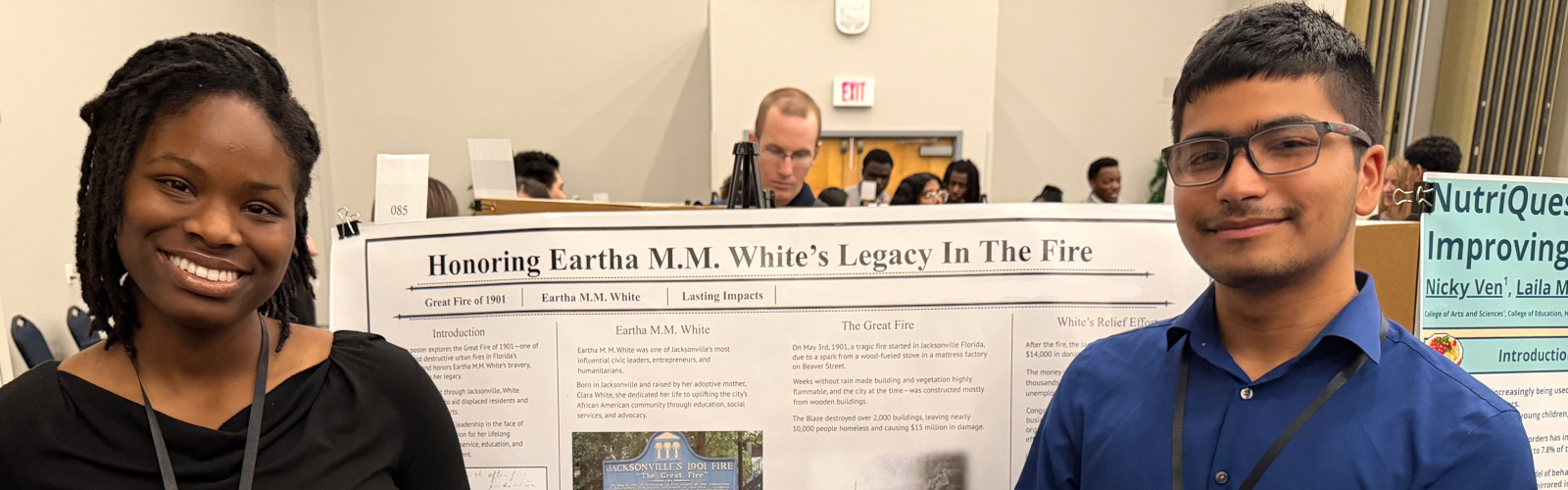 Two students in front of a research poster