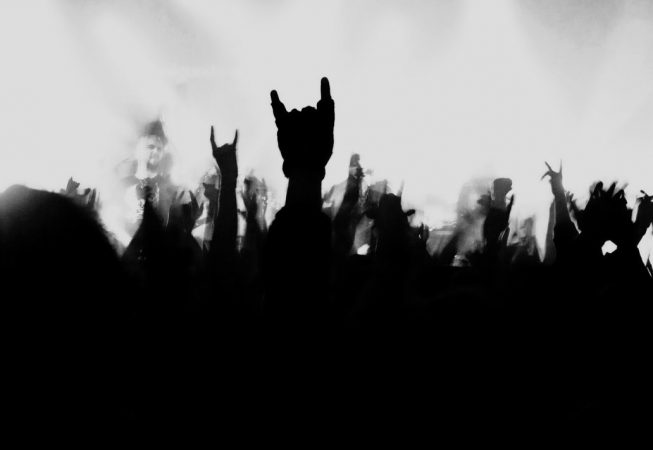 White background with shadow hands doing the rock and roll symbol