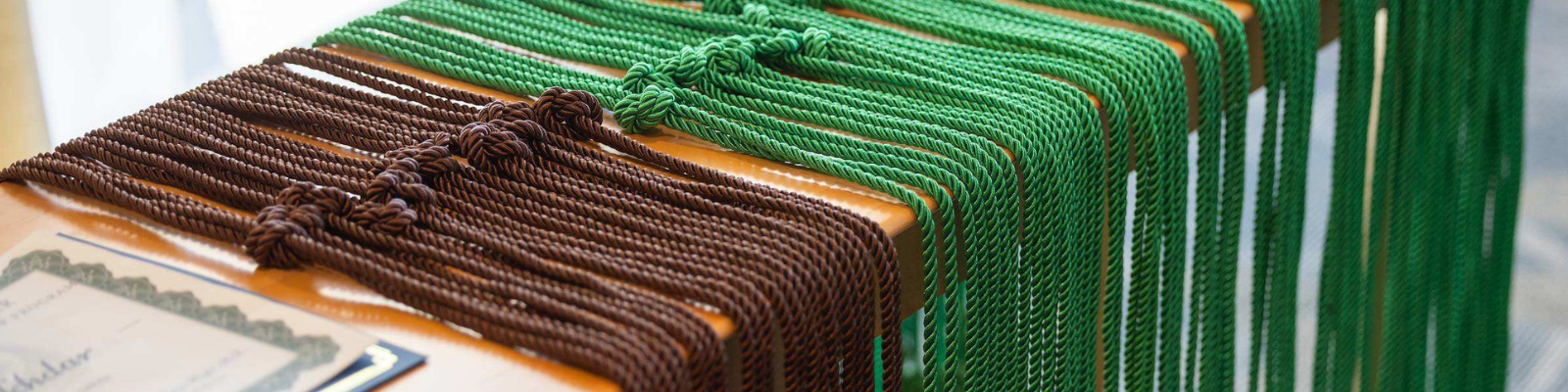 Graduation cords draped over a table.