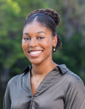 Headshot photo of Lauren Canady with nature background.