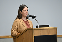 Assistant Director, Kelly Rhoden speaking at the podium during the ELP Symposium.