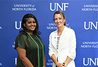 Dr. Largo-Wight pictured standing next to ELP student that just received green cords for graduation.