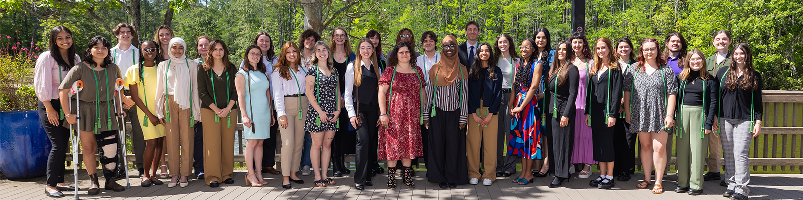 Large group of individuals in two lines posing for group photo.