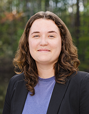 Headshot of student, Ella, with a nature backdrop.