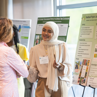 Person presenting a poster on outdoor engagement projects.