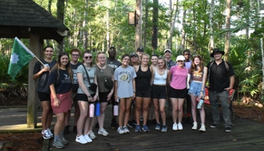 Living Learning Community students group photos on boardwalk in preserve.