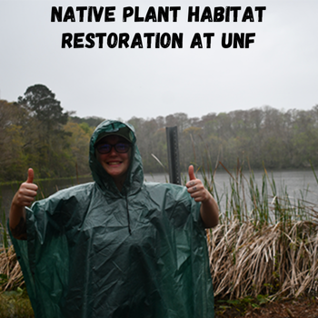 Student in green rain poncho standing in preserve while it is raining.