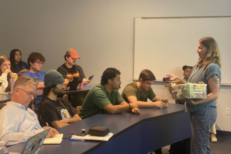 Students in a classroom listening to a speaker