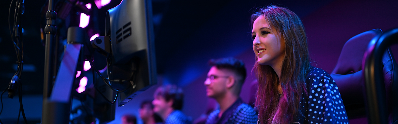 Esports player smiling at computer