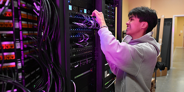 Student smiling at cables