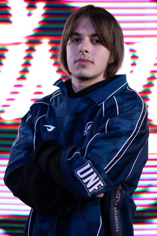 Caleb Dyer for Fighting Games Varsity wearing a UNF Esports jersey