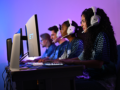 Esports team wearing headsets working on monitors