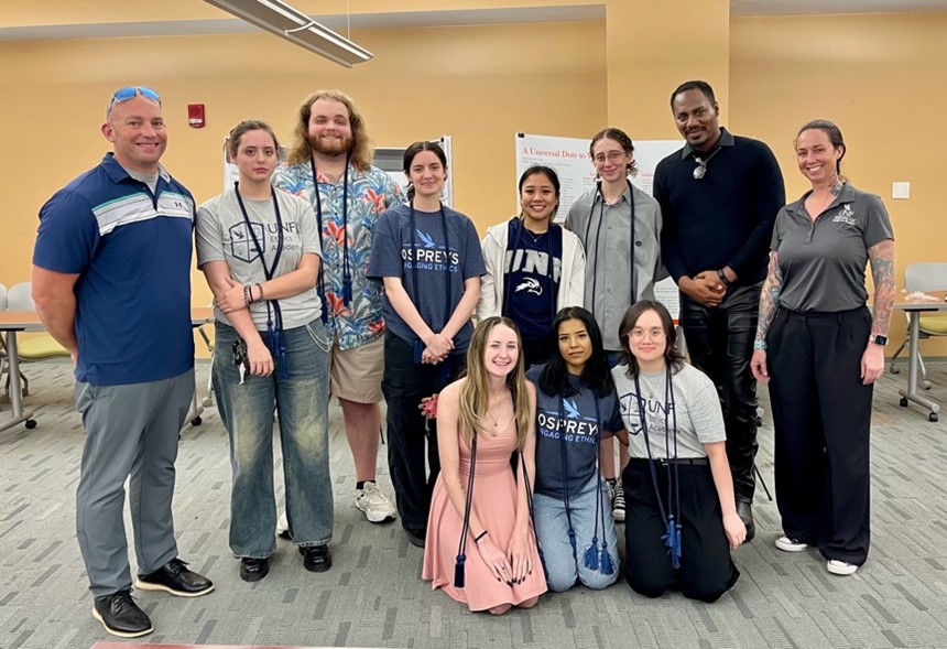 Picture of Ethics Scholars wearing cords for graduation.