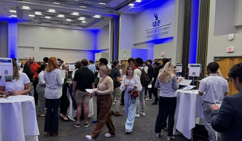 Foundation of Business students mingle at a networking event.