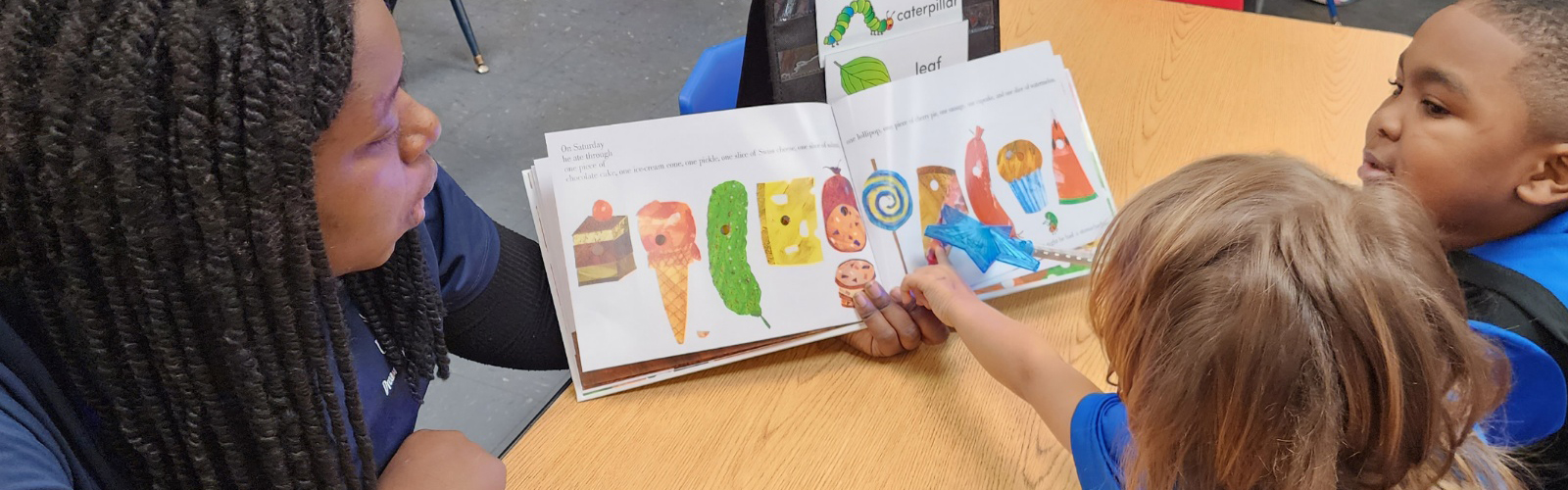 UNF Dream Promoter reading to the children at a center.