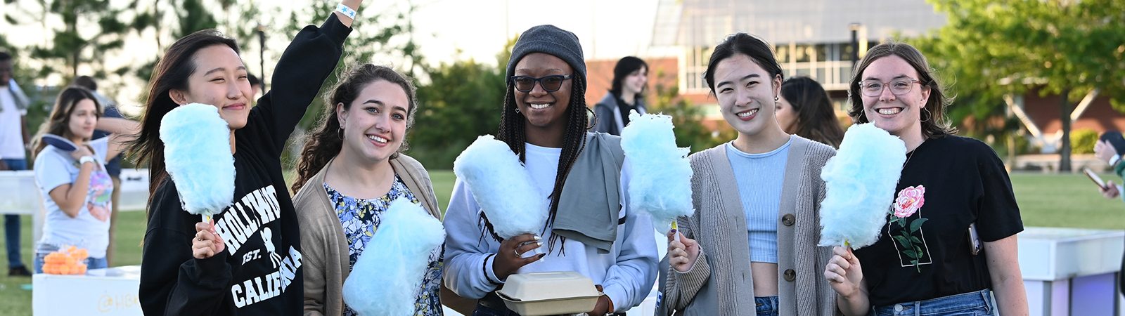 UNF students posing for a group photo with cotton candy