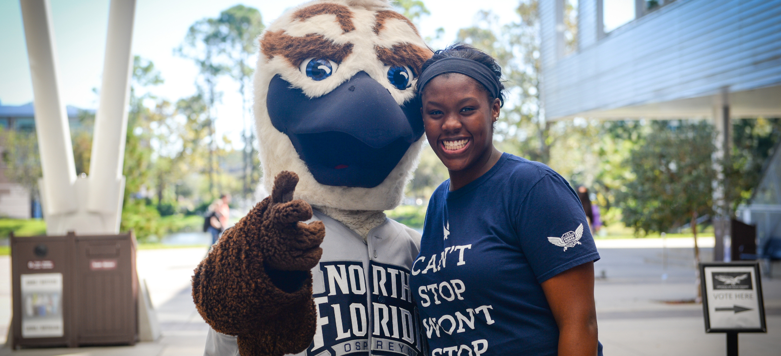 Ozzie Osprey with a female student smiling excitedly
