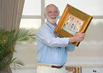 berg holding up a painting