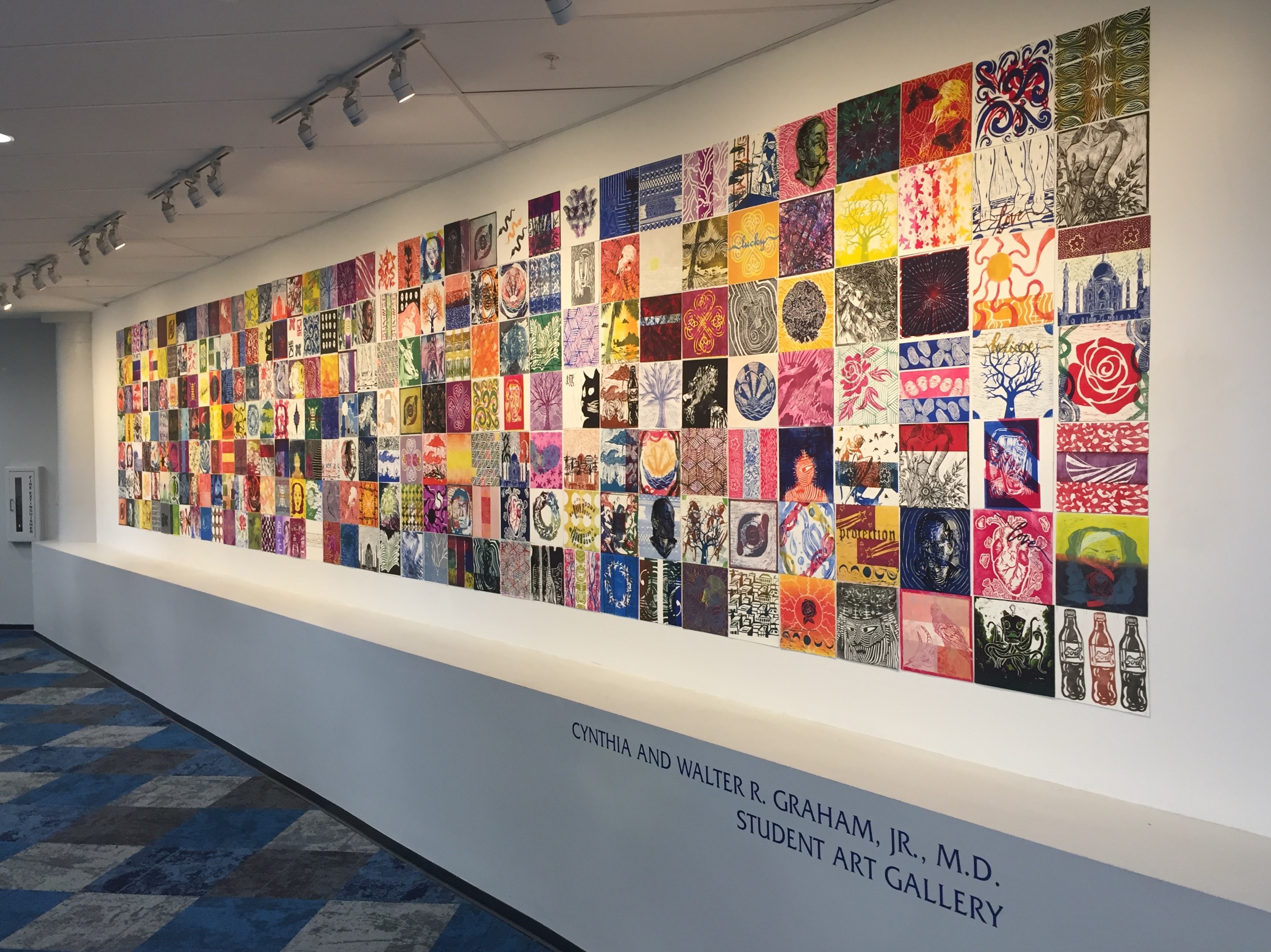 Colorful mural featuring a variety of artistic tiles displayed in the Cynthia and Walter R. Graham, Jr. M.D. Student Art Gallery.