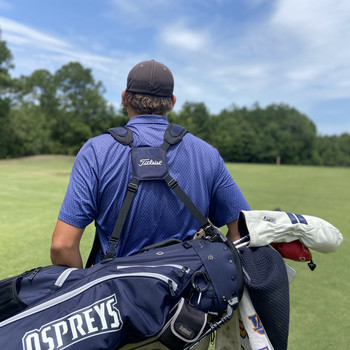 back of a golf player holding Titleist and UNF golf gear