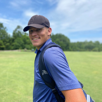 golf player smiling on golf course