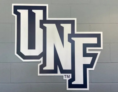 UNF athletics logo on grey brick wall