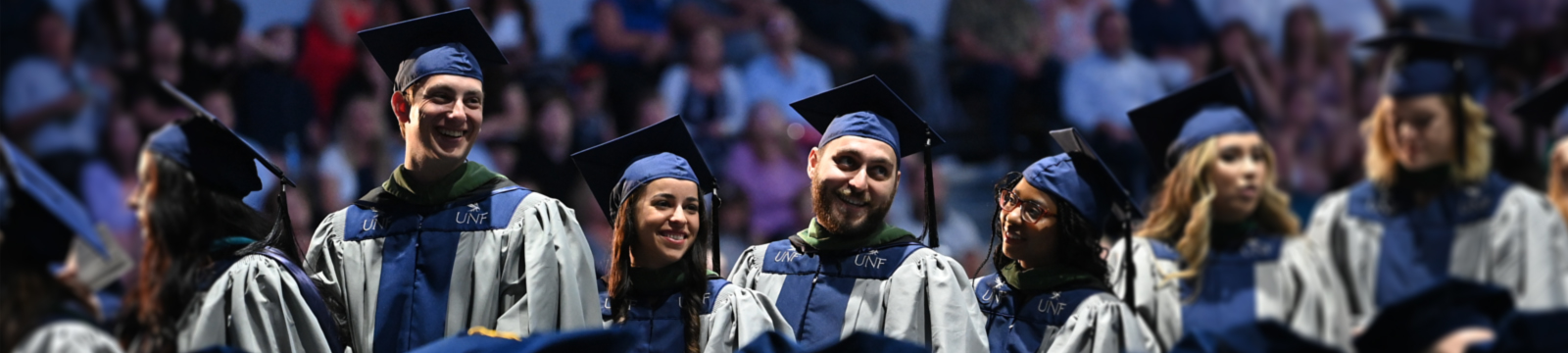 graduate students at graduation lined up in row