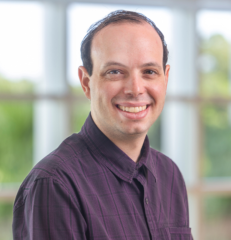 Smiling alumni headshot with windowed background