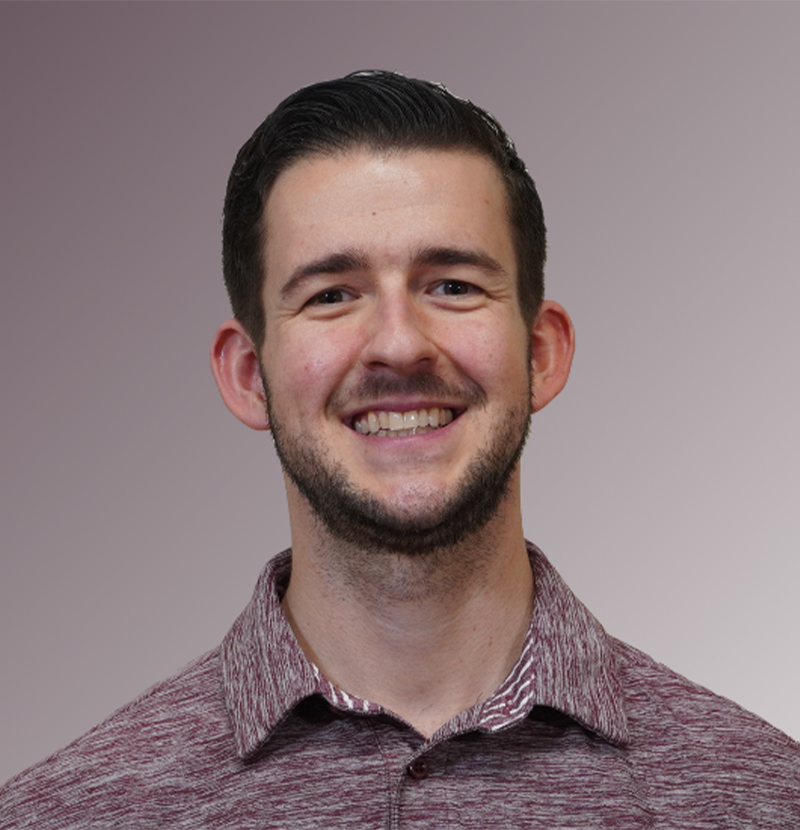Smiling alumni headshot with mauve gradient background