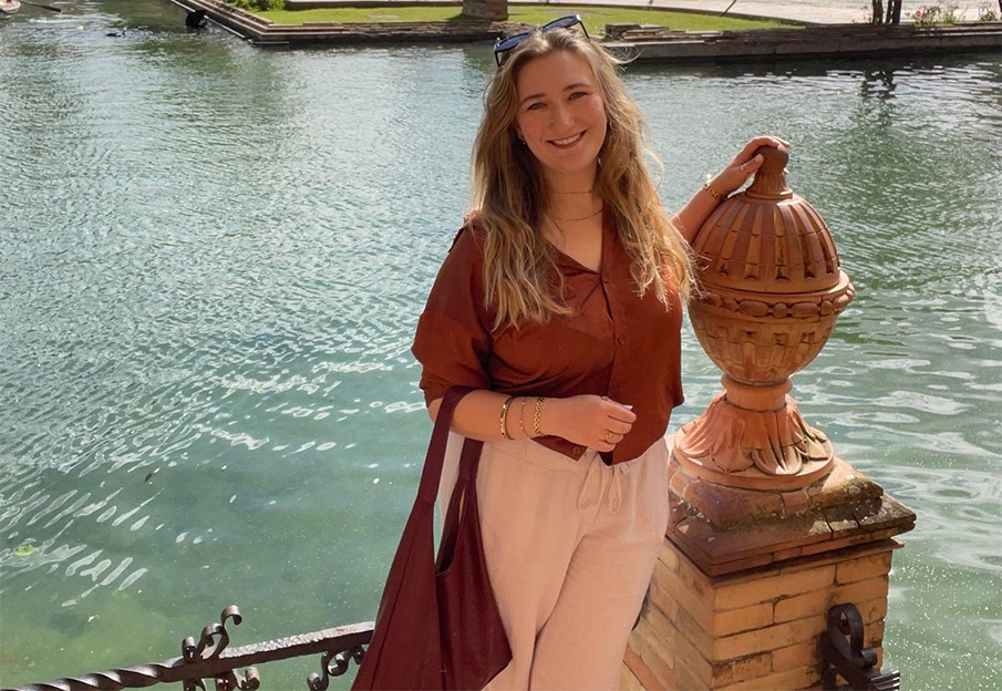 Rosemarie Baker in front of a large fountain in Spain