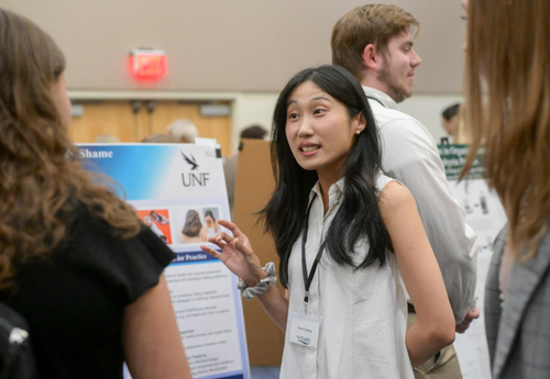 Student presenting research at UNF poster session