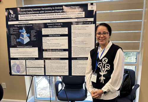 Syeda Hyder standing beside her research poster on addressing learner variability in online course design using Universal Design for Learning.