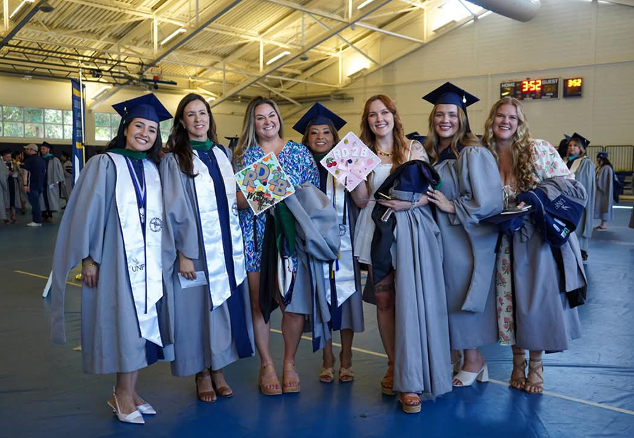 Seven nutrition and dietetic graduates standing together 