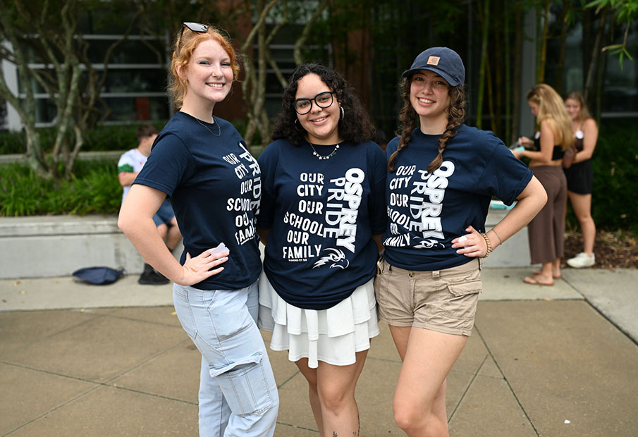 Three UNF students wearing Osprey T-shirts