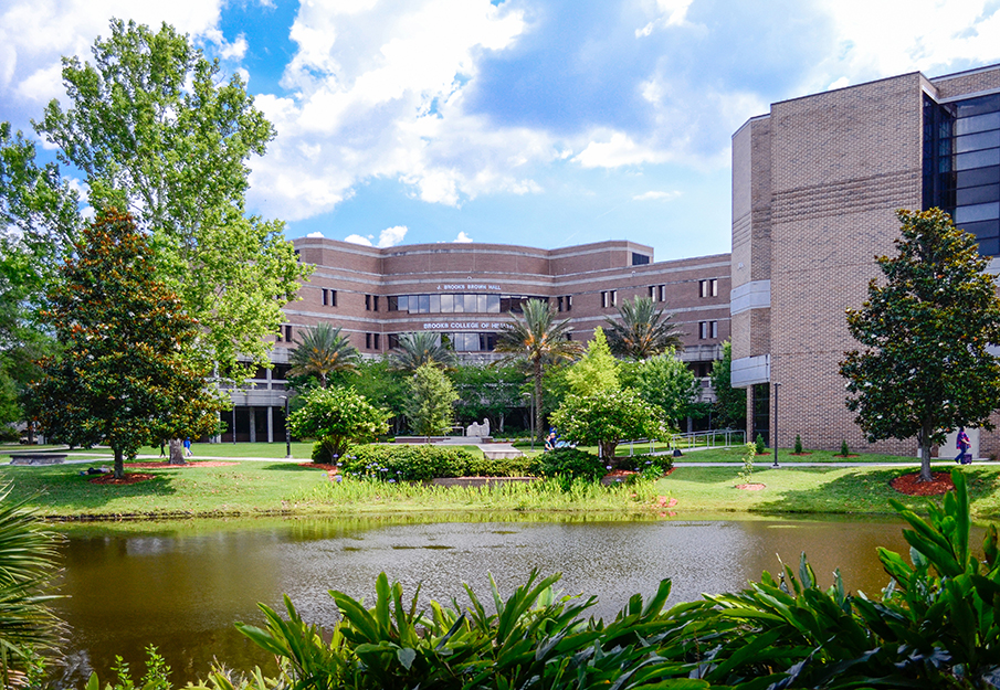 Pond view of Brooks College of Health Building